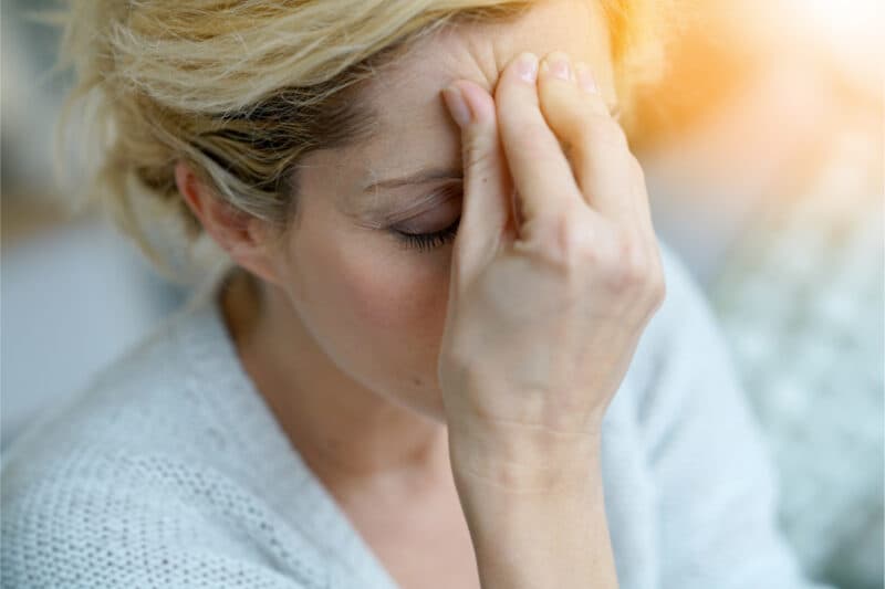 Close-up of a middle-aged woman having a migraine